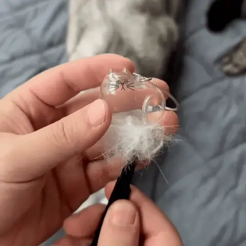 Close-up of an EternalPaw keychain being filled with pet fur